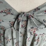 American Eagle Outfitters-Green floral top-size medium Super cute floral top, side cut outs, smocked back, adjustable straps, excellent condition Measurements: Bust: armpit to armpit 17-19 inches Length: shoulder seam to bottom 21 inches Photo 1