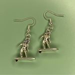 Silver Tone Surfer Girl Earrings Photo 0