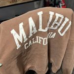 Brandy Melville  brown zip up sweater with graphic letters on the back Photo 1