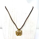 Mayan design gold tone pendant purchased in Costa Rica, on brown suede cord Photo 1