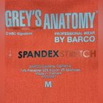 Grey's Anatomy V-Neck Short Sleeve scrub Top in Coral/orangish. Size Medium. Photo 6