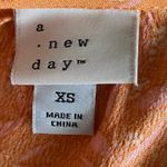 A New Day Stunning midi dress, orange with little pink flowers, ruffle bottom, excellent condition, size xs Measurements: Bust: armpit to armpit 18 inches Waist: side to side 13-16 inches Length: shoulder seam to bottom 44 inches Photo 6