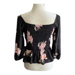 Allie Rose NWT- Beautiful black top with pink flowers, smocked back, 3/4 sleeves, ruffle bottom, brand new, size medium  Measurements: Bust: armpit to armpit 17-20 inches  Waist: side to side 14-16 inches  Length: shoulder seam to bottom 33 inches Photo 6