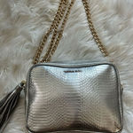 Victoria's Secret Victoria secret silver crossbody purse w gold chain and tassel Photo 0