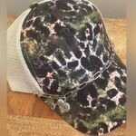 Boutique Criss Cross Ponytail Hat featuring a camo print and a Mom Heart Trucker Band. Photo 4