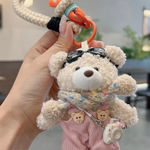 Adorable fluffy black monster keychain with big cartoon eyes and white feet. Photo 0