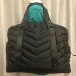 Cynthia Rowley Anthropologie’s Quilted Puffer Travel Bag is a stylish and functional accessory designed for travel enthusiasts. Crafted from high-quality materials, this bag features a quilted exterior for added texture and durability. Its spacious interior provides ample room for belongings, while the thoughtful design includes convenient pockets for organization. The soft puffer style adds a chic touch, making it suitable for various occasions, whether heading to the gym or embarking on a weekend getaway. With comfortable straps for easy carrying, this travel bag combines practicality with fashionable flair. Photo 0