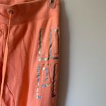 PINK - Victoria's Secret VS Pink orange coral flare sweatpants Photo 1