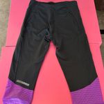 Under Armour Black and Purple capri length Leggings with Mesh Detail Photo 1