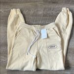 Dippin' Daisy's NWT Dippin’ Daisy’s Yellow Smile Sweatpants Size Small Photo 0