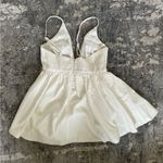 San Joy  Deep V Neck Low Cut Asymmetrical Ruffle Romper Dress in white Photo 5