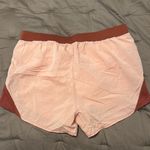 Under Armour  Women's Shorts in Light Pink and Rust Photo 1