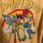 Disney  Pixar Toy Story “Sunnyside Day Care” Yellow Crewneck Sweatshirt Size XXL Photo 1