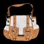 Franco Sarto  tan and cream saddle style bag. Has a tear in the pocket inside Photo 1