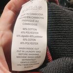 Michael Kors NWT  MK Print Logo Sweater Crew Neck Knit Black Red Size XS $110  New with tag  Same day shipping  Smoke and pets free  Elevate your wardrobe with this stunning  sweater featuring the iconic MK print logo in black and red. The crew neck and long sleeves provide a classic silhouette while the knit fabric type makes it lightweight and breathable. Perfect for any occasion, this sweater comes in size XS and is a regular fit. The accents of the logo add a touch of elegance to the overall look. Ideal for women who love colorful themes, this sweater is a must-have in your closet. Photo 5