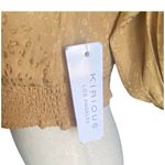 Kirious NWT- LOS ANGELES-SIZE SMALL Gorgeous gold color crop top, elastic bottom, v neck, open back, long sleeves, size small Measurements: Bust: armpit to armpit 15 inches  Length: shoulder seam to bottom 15 inches Photo 4