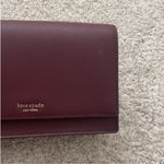 Kate Spade  Maroon Crossbody Bag with Gold Chain Strap. Photo 2