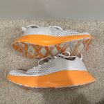 Nobull Journey running shoe in white with an orange midsole Photo 2