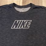 Nike women’s black/white Dri-Fit shirt with logo on sleeves size L Photo 1