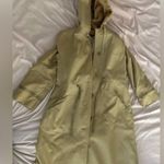 Tan Trench Coat with Hood and Water Photo 0