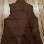 Old Navy Stay warm and stylish with this brown sleeveless puffer vest. Perfect for layering in cooler weather. Photo 1