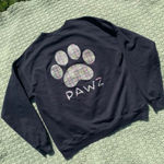 Pawz  black sweatshirt with a plaid paw at the back
No size tag Photo 0