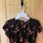 Jolt  Black Top with Vibrant Floral Accents Photo 1