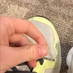 on cloud On Running women’s white sneakers with dark grey laces and neon yellow details Photo 4