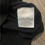  black and white  tank top. Features white Nike logo and straps. Photo 3