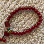 Red Beaded Bracelet With Chinese Design and Small Green Bead Photo 2
