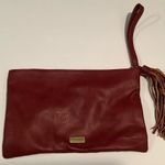 Carlos Santana  burgundy clutch Photo 1
