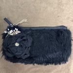 Elegant Black Clutch with Floral Accent Photo 0