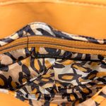 Franco Sarto  tan and cream saddle style bag. Has a tear in the pocket inside Photo 3