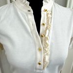 Tory Burch Emily Ruffled Pique Polo Shirt in Ecru. Photo 1