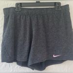 Nike gray women’s dri-fit athletic shorts with pink swoosh detailing; size XL Photo 0