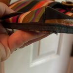 Fossil multicolor purse with adjustable strap in GUC. One small tear on bottom. Photo 5