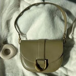 Charles and Keith ’s signature Gabine leather saddle bag Photo 0