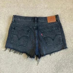Levi's Levi’s 501 black ripped high rise jean shorts in size 28 Photo 1