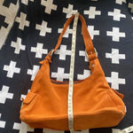 XOXO Orange suede shoulder bag with an organic rustic look Photo 8