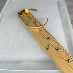 Avon gold tone V shaped cuff bracelet with faux ruby or garnet. Large Photo 4