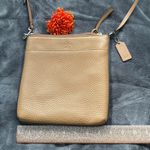 Coach | pebbled leather crossbody. Falls flat against body. Photo 5