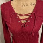 Divided Raspberry colored long sleeve shirt with lace up front. Photo 1