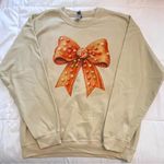 Gildan Cream Sweatshirt with Orange Gingerbread Bow. Size L. NWOT Photo 0