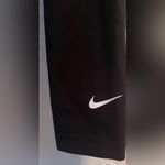Nike women’s black leggings, white swoosh logo on bottom ankle; size S Photo 1