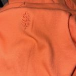 Free People NWOT FP movement flow state layer ribbed ruched sleeve color orange thermal Top Photo 6