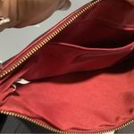 Carlos Santana  burgundy clutch Photo 5