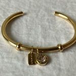 Coach: Gold Tone Charm Braclet- 2 charms- coach tag & rhinestone- open/slide on Photo 0