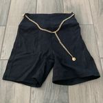 We Wore What  black biker shorts with gold chain belt Photo 0