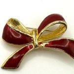 AAI red enamel and gold tone bow brooch Photo 0