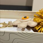 Eye Candy | Faux Leather Sunflower w/ Pom-Pom Bag Charm Photo 5